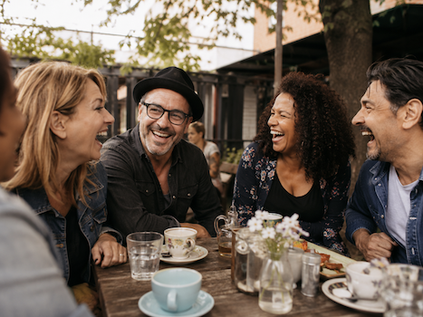 Laughing adults at cafe