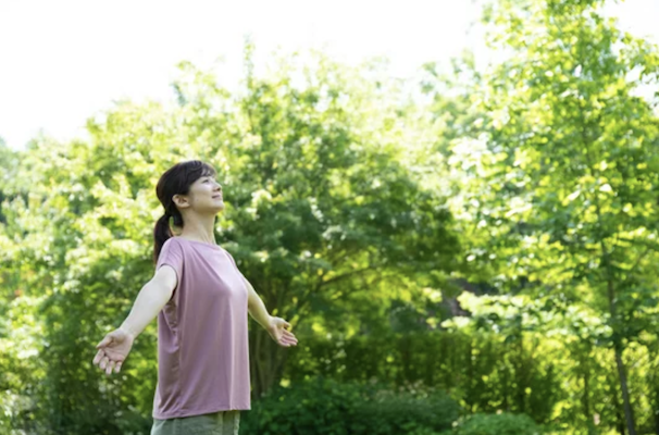 Asian lady outside breathing