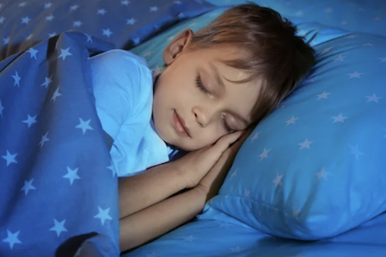 Sleeping boy in star sheets